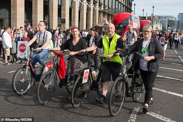 Hundreds of people rode with posters campaigning for a 'national protected cycle-lane network' and to stop 'lethal transport pollution'