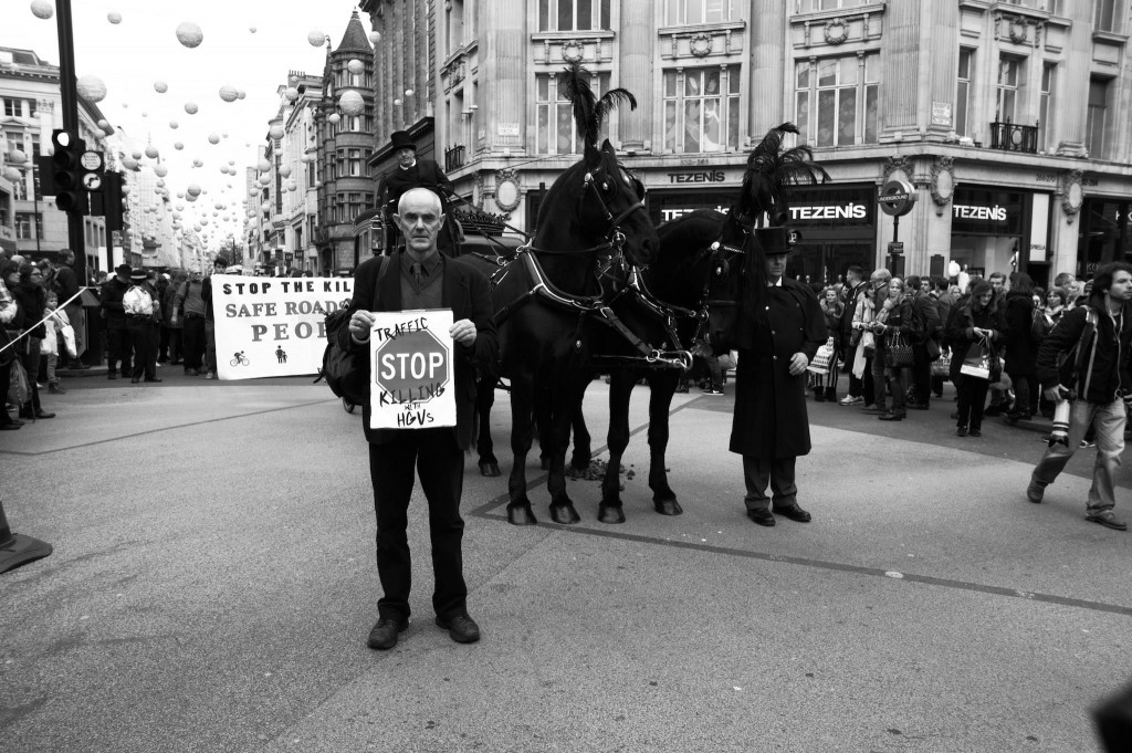 Donnachadh McCarthy, co-founder of Stop Killing Cyclists, stands in Oxford Circus, as part of the National Funeral for the Unknown Victim of Traffic Violence protest organised by the Stop The Killing coalition (Photo by Brendan Delaney, used with permission, click to see larger version)